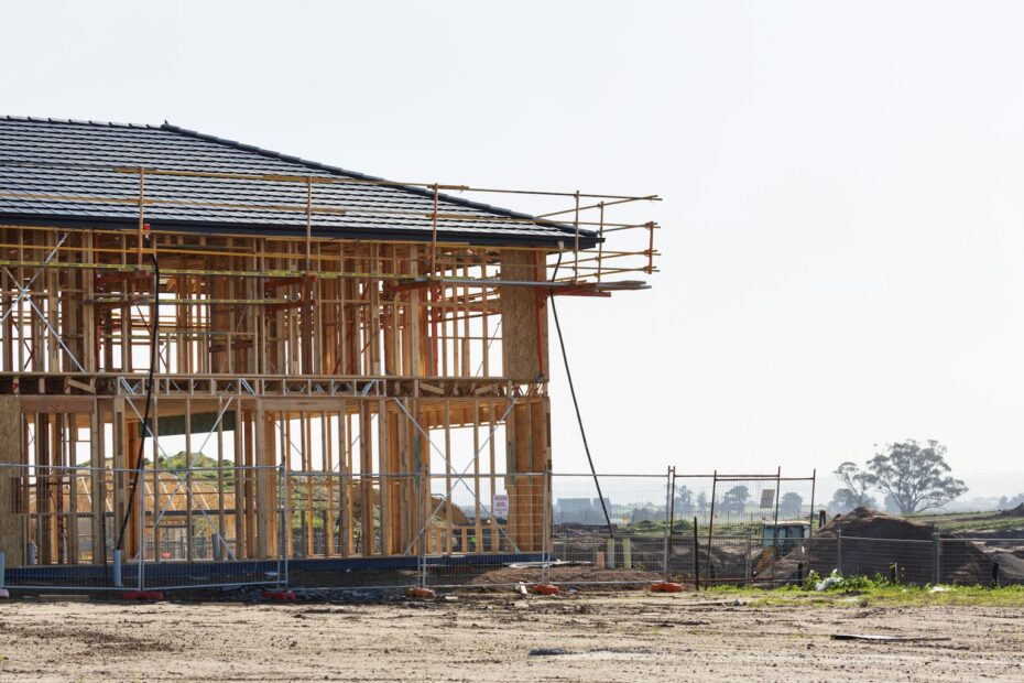 Two-story house framed with scaffolding at a new construction site