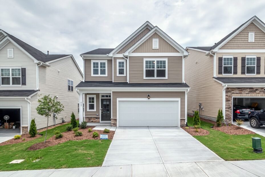 Row of newly built two-story homes with fresh lawns in a suburban neighborhood