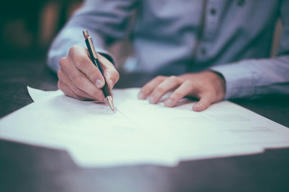 Investor signing loan documents at a desk